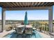 Deck with patio furniture and umbrella, overlooking beautiful scenery at 10520 W Vassar Dr, Lakewood, CO 80227