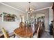 Bright dining room with a large table and access to the living room at 10520 W Vassar Dr, Lakewood, CO 80227