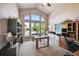 Home office with built-in shelving and large window at 10520 W Vassar Dr, Denver, CO 80227