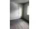 This carpeted bedroom is illuminated by a window and also has a door at 6029 S Sycamore St, Littleton, CO 80120