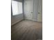 Carpeted bedroom featuring a window with blinds and a white door at 6029 S Sycamore St, Littleton, CO 80120