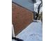 This brick exterior is on a snow-covered lot and has steps leading to a doorway at 6029 S Sycamore St, Littleton, CO 80120