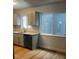 This well-lit kitchen features modern countertops, cabinetry and flooring at 6029 S Sycamore St, Littleton, CO 80120