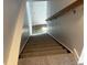 Stairway leading into the home, featuring neutral walls and a wooden handrail at 6029 S Sycamore St, Littleton, CO 80120