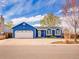 Charming single-story blue home with a well-maintained lawn and attached two-car garage at 4269 Freeport Way, Denver, CO 80239