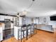 Open concept kitchen with a breakfast bar, stainless steel appliances, and stylish black and white floors at 4269 Freeport Way, Denver, CO 80239