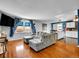 Bright living room featuring hardwood floors, a comfortable gray sofa, and large windows at 4269 Freeport Way, Denver, CO 80239