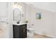 Stylish bathroom with dark vanity, gold accents, and arched mirror at 7204 W 26Th Ave, Lakewood, CO 80214