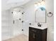 Modern bathroom with a large shower, floating vanity, and skylight at 7204 W 26Th Ave, Lakewood, CO 80214