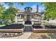 Charming home featuring white painted brick, black trim, and a covered front porch at 7204 W 26Th Ave, Lakewood, CO 80214