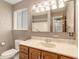 Cozy bathroom offering a classic vanity, updated fixtures, and a large mirror at 406 Titan Ct, Aurora, CO 80011