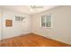 This bedroom has hardwood flooring, neutral walls and a large window for plenty of natural light at 406 Titan Ct, Aurora, CO 80011