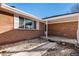 Charming brick home featuring covered front entrance and well-maintained landscaping at 406 Titan Ct, Aurora, CO 80011