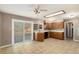 Bright eat-in kitchen featuring wood cabinetry, tile flooring and a sliding glass door for outdoor access at 406 Titan Ct, Aurora, CO 80011