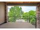 Spacious balcony showcasing stone accents and a wooden floor with scenic treetop views at 2114 Lowell Blvd, Denver, CO 80211