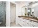 Modern bathroom featuring double sinks, tiled shower, and a separate water closet at 2114 Lowell Blvd, Denver, CO 80211
