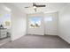 Bright bedroom featuring neutral carpet, a ceiling fan, and natural light from multiple windows at 2114 Lowell Blvd, Denver, CO 80211