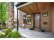 Inviting front porch with stone pillars, a modern door, and a cozy seating area at 2114 Lowell Blvd, Denver, CO 80211