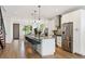 Modern kitchen featuring white cabinets, a center island with seating, and stainless steel appliances at 2114 Lowell Blvd, Denver, CO 80211