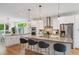 Spacious kitchen featuring a large island with seating, modern appliances, and stylish pendant lighting at 2114 Lowell Blvd, Denver, CO 80211