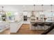 Bright, modern kitchen with white cabinetry, stainless steel appliances, and an island with bar stools at 2114 Lowell Blvd, Denver, CO 80211
