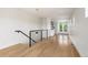 Hardwood floors with staircase with metal railing leading upstairs and bar area visible at 2114 Lowell Blvd, Denver, CO 80211