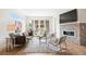 Cozy living room with a modern fireplace, stylish seating, and a view of the outdoor patio at 2114 Lowell Blvd, Denver, CO 80211