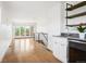 Bright living room with hardwood floors, mini-bar area, and large glass doors to the outside balcony at 2114 Lowell Blvd, Denver, CO 80211