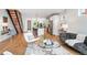 Open-concept living room with hardwood floors, modern staircase, and a view of the kitchen at 2114 Lowell Blvd, Denver, CO 80211