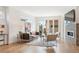 Bright living room featuring hardwood floors, large windows, and a modern fireplace with stone accents at 2114 Lowell Blvd, Denver, CO 80211