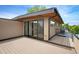 A modern rooftop deck boasts sleek black metal railings and large glass doors, blending indoor/outdoor living at 2114 Lowell Blvd, Denver, CO 80211