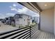 Balcony with a view of the surrounding neighborhood and a sleek black railing at 12225 W 57Th Pl, Arvada, CO 80002