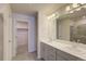 Modern bathroom with double vanity, sleek gray cabinets, walk in shower and walk in closet at 12225 W 57Th Pl, Arvada, CO 80002