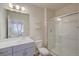 Well-lit bathroom featuring a glass shower, modern fixtures, and ample counter space at 12225 W 57Th Pl, Arvada, CO 80002