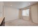 Empty bedroom featuring carpet, window with neutral curtain, and off-white paint at 12225 W 57Th Pl, Arvada, CO 80002