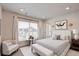 Bright bedroom with a large window, white curtains, stylish furniture, and recessed lighting at 12225 W 57Th Pl, Arvada, CO 80002