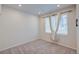 Unfurnished bedroom featuring carpet, window with neutral curtain, and off-white paint at 12225 W 57Th Pl, Arvada, CO 80002