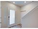 Bright entryway with frosted glass door, coat hooks, and modern flooring at 12225 W 57Th Pl, Arvada, CO 80002