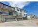 Exterior view of townhome with multi-car garages, multiple levels and private balconies at 12225 W 57Th Pl, Arvada, CO 80002