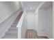 Welcoming hallway with a staircase, hardwood floors, and a white front door at 12225 W 57Th Pl, Arvada, CO 80002