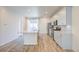Bright kitchen with stainless appliances, island and sleek white cabinets and hardwood floors at 12225 W 57Th Pl, Arvada, CO 80002