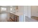 Open kitchen layout featuring an island with a sink, stainless steel appliances, and wood floors at 12225 W 57Th Pl, Arvada, CO 80002
