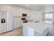 Modern kitchen featuring gray cabinets, stainless steel appliances, and a large island at 12225 W 57Th Pl, Arvada, CO 80002