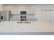 Bright kitchen with gray cabinets, stainless steel appliances, and a center island at 12225 W 57Th Pl, Arvada, CO 80002
