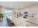 Eat-in kitchen featuring gray cabinets, stainless appliances, and a large island with bar stool seating at 12225 W 57Th Pl, Arvada, CO 80002