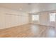 An open and airy room featuring wood floors, neutral walls, and natural light at 12225 W 57Th Pl, Arvada, CO 80002