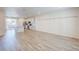 Spacious living room with neutral walls, hardwood flooring and an open kitchen at 12225 W 57Th Pl, Arvada, CO 80002