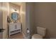 Stylish bathroom with a white vanity, round mirror, and modern fixtures at 8695 Thunderbird Cir, Parker, CO 80134