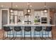 Modern kitchen with a large island and pendant lighting at 8695 Thunderbird Cir, Parker, CO 80134