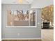 Living room with a stone fireplace and large window showcasing the outdoor view at 13633 E Yale Ave # B, Aurora, CO 80014